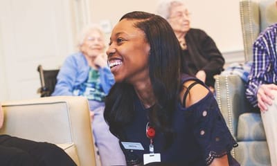 Staff member engaging with residents in a common area