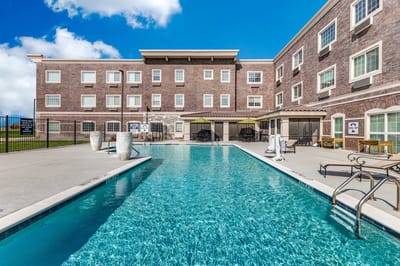 Outdoor pool area with seating and umbrellas
