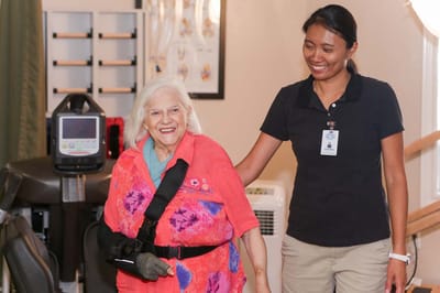 A staff member assisting a resident indoors.