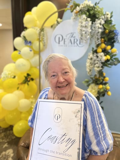 A resident holding a sign celebrating a transition event