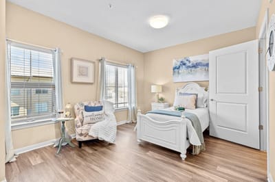 Brightly lit private resident room with decorative touches