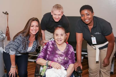 Staff and residents enjoying time together in a facility room