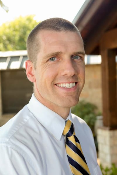 Portrait of a smiling male staff member outdoors
