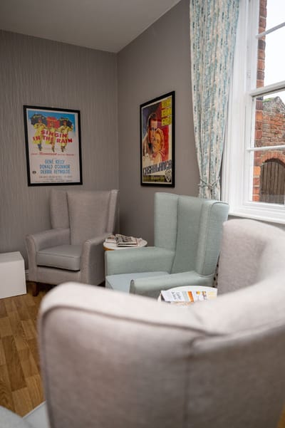 Cozy common area with comfortable seating and vintage posters