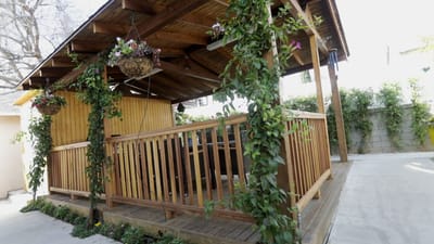 Outdoor gazebo with lush greenery and seating