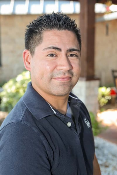 Staff member posing outdoors in a casual setting