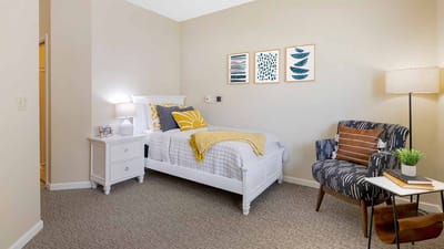 Cozy resident room with bed and artwork