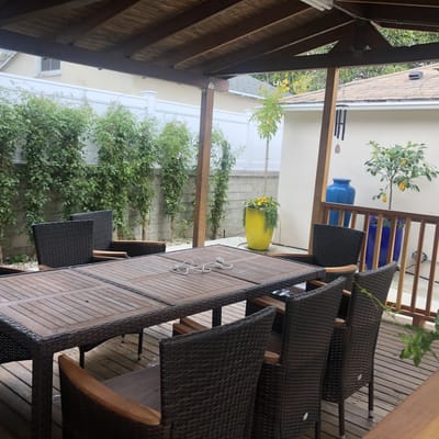 Outdoor dining area with a wooden table and chairs