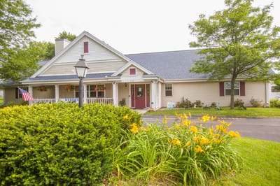 Exterior view of Maple Meadows Assisted Living with flowers
