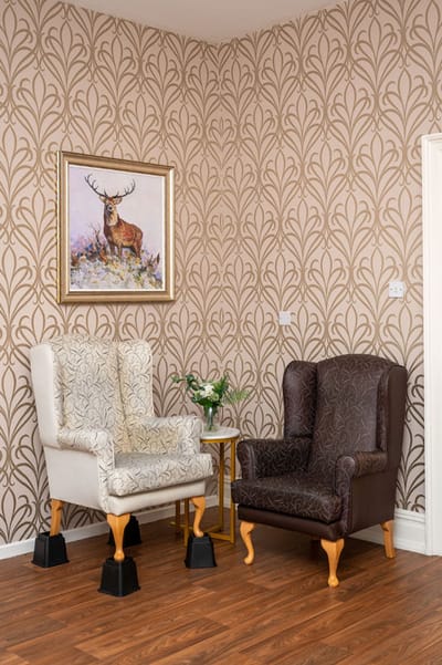 Lound Hall Nursing Home, nursing home — Two stylish armchairs beside a decorative wall