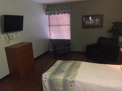 Cozy resident room with a bed and seating area