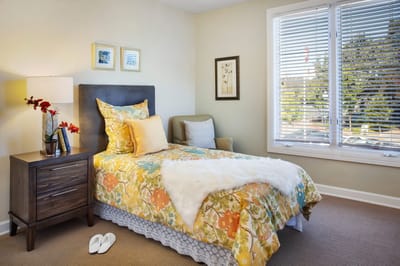 Cozy resident room with bright bedding and decor