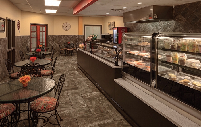 Bright dining area with dessert display and tables