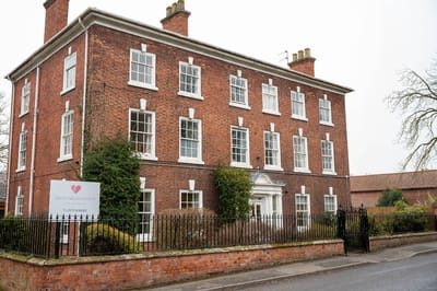 Lound Hall Nursing Home, nursing home — Historic brick nursing home building with garden and sign