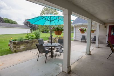 Outdoor patio area with seating and umbrella