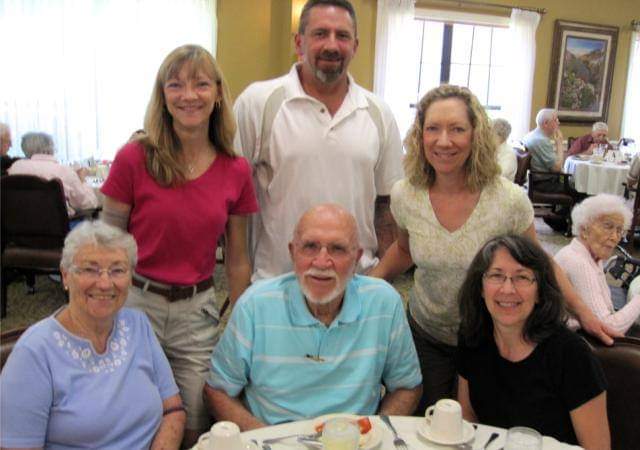 Residents and staff enjoying a meal together