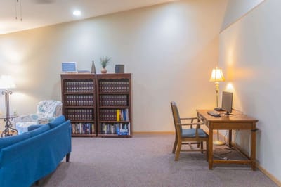Cozy common area with seating and bookshelves