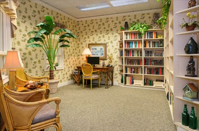 Cozy reading nook with bookshelves and plants