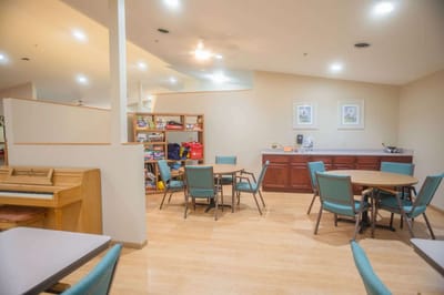 Interior common area with tables and a piano