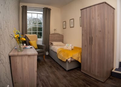 Cozy resident room with warm colors and furnishings