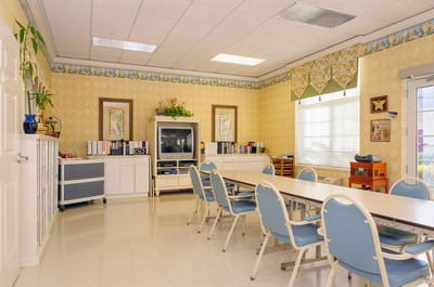 Bright activity room with tables and chairs
