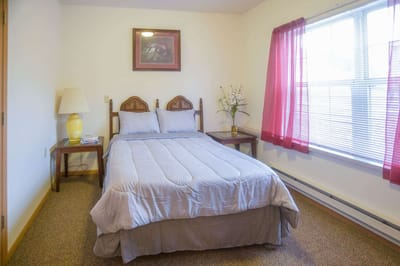 Cozy resident room with a double bed and natural light