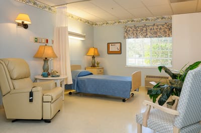 Brightly lit resident room with comfortable furnishings