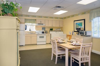 A bright kitchen area with dining table set