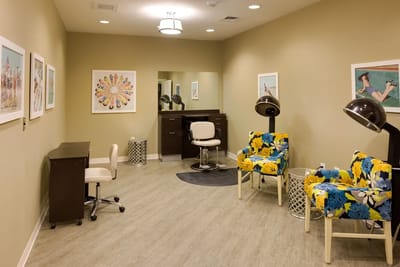 Hair salon with colorful chairs and artwork