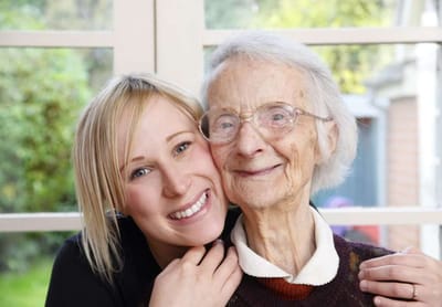 A staff member smiling with a resident