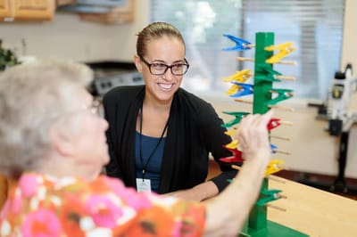 Resident and staff member engaged in an activity