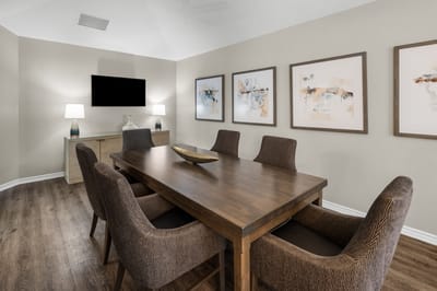 Interior of a common area with a dining table and artwork