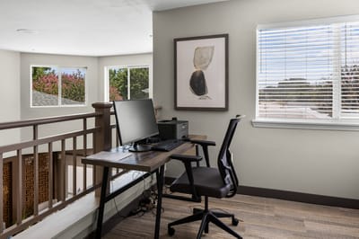 Interior space with a desk and computer by the window