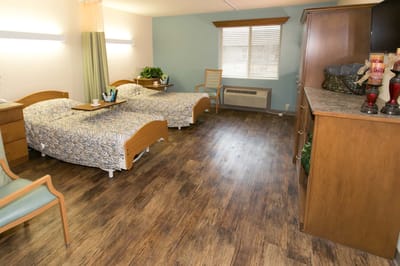 Clean and well-lit resident room with two beds