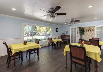 Bright dining room with tables set for residents