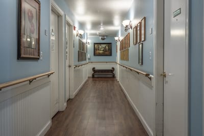 A well-lit hallway in an assisted living facility