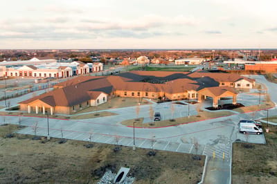 Aerial view of the assisted living facility with parking lot