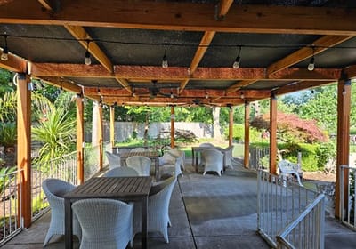 Outdoor patio area with seating and greenery