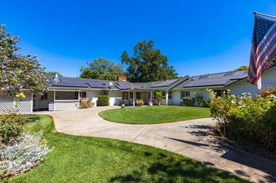 Exterior view of an assisted living facility with garden