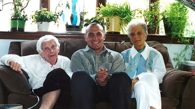 A caregiver with two elderly residents in a cozy setting