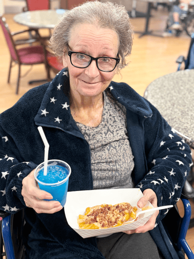 Resident enjoying food and a drink in the common area