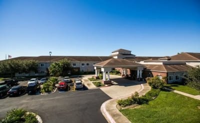 Exterior view of Azalea Estates with garden and parking area