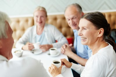 Residents enjoying coffee and conversation at a table