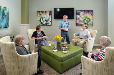 Residents enjoying conversation in a cozy lounge area
