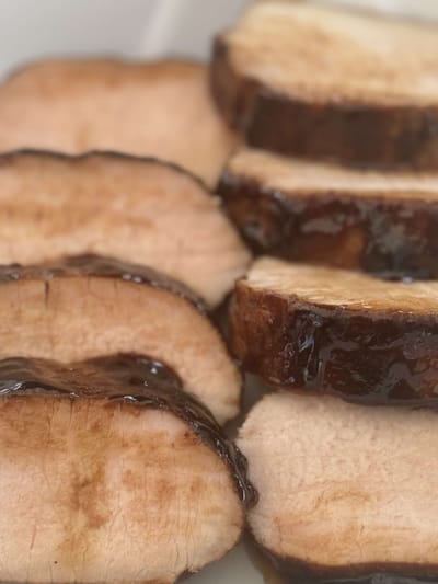 Sliced pork tenderloin served on a plate