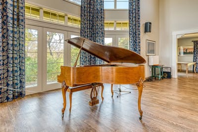 Interior view of a common area with a grand piano