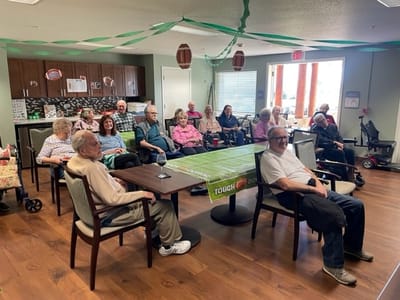 Residents engaged in a community gathering in a lounge