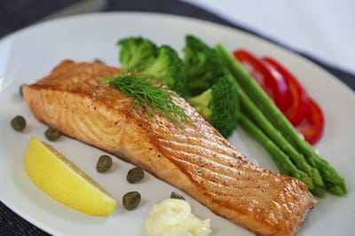 Plated meal of salmon with vegetables