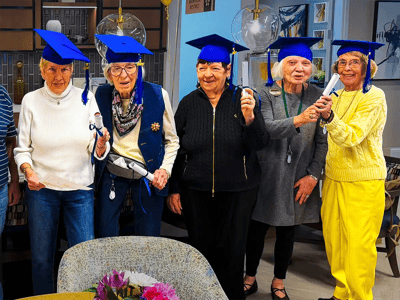 Residents celebrating with graduation caps