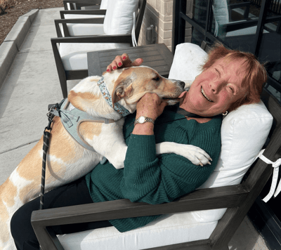 Resident enjoying time with a dog outdoors